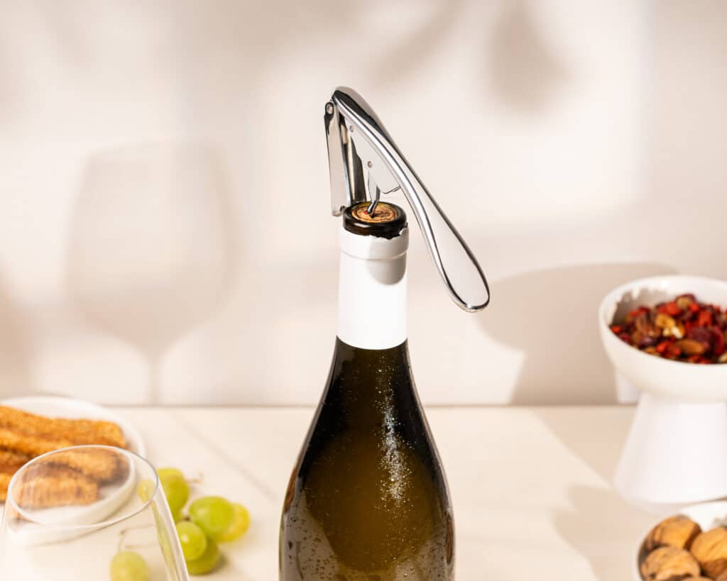 Tire-bouchon sommelier sur une bouteille de vin lors d'un apéritif
